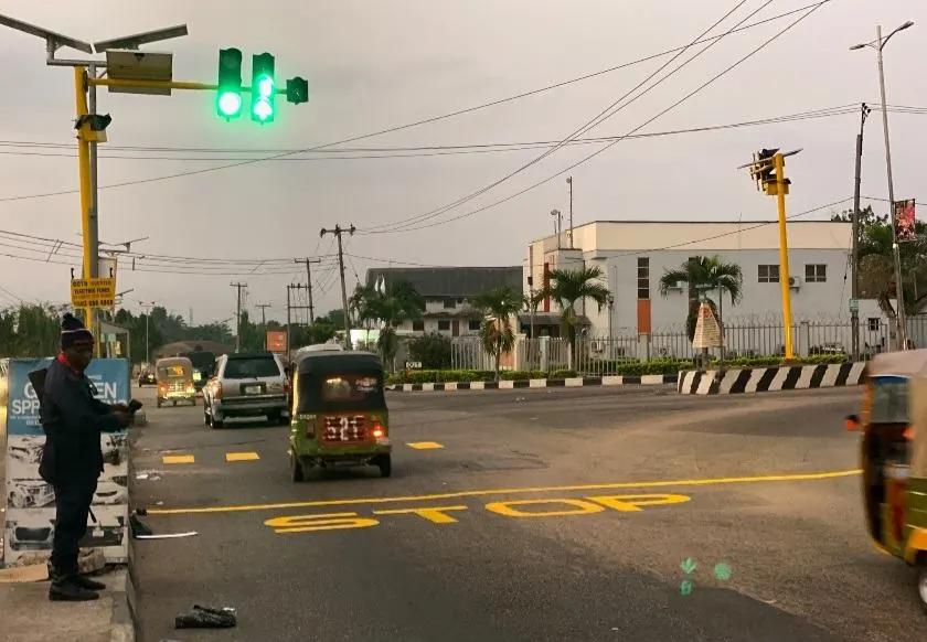 Solar traffic light green signal, daytime junction
